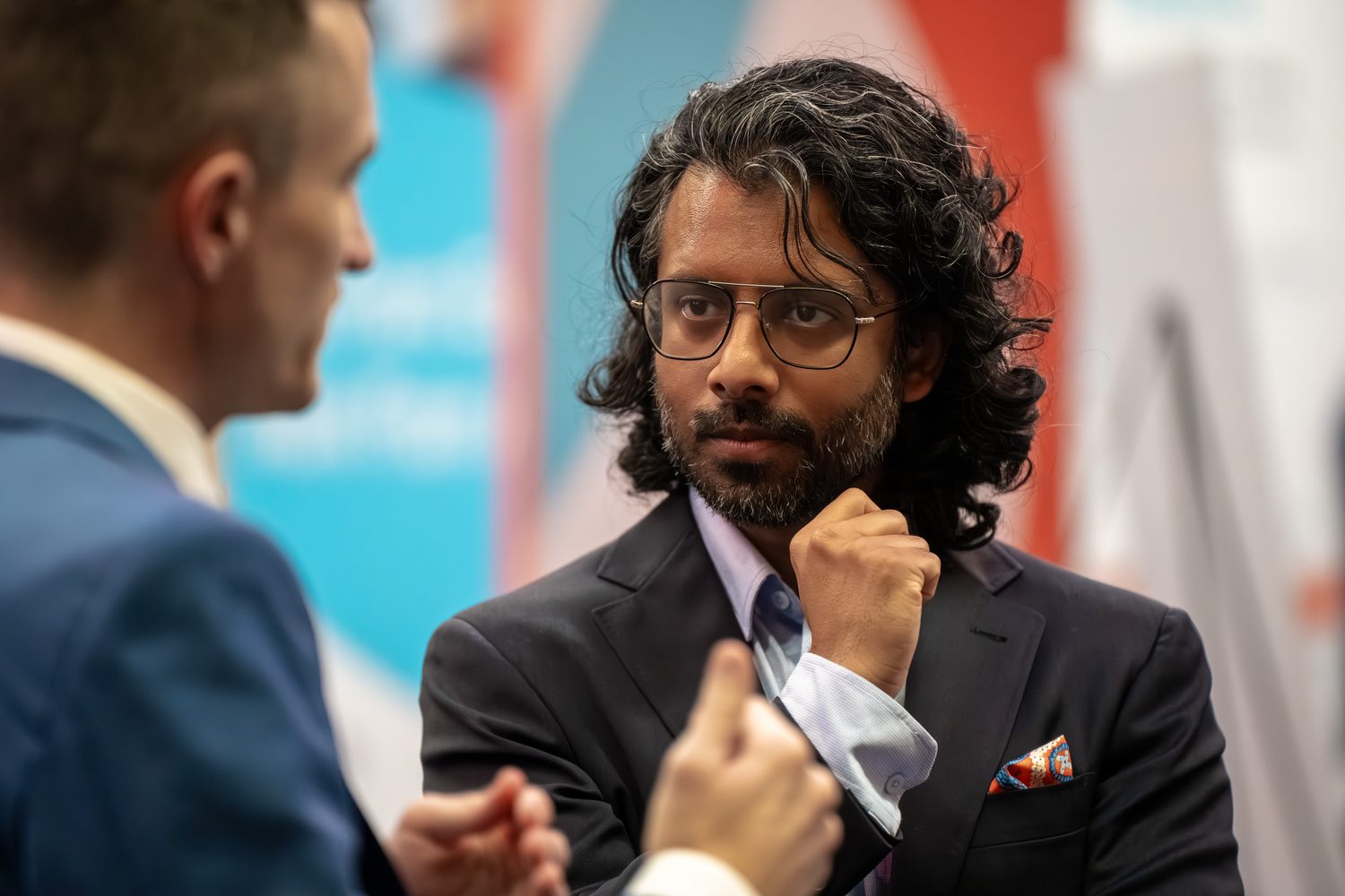 Speaker listening closely during a one-on-one conversation at the event