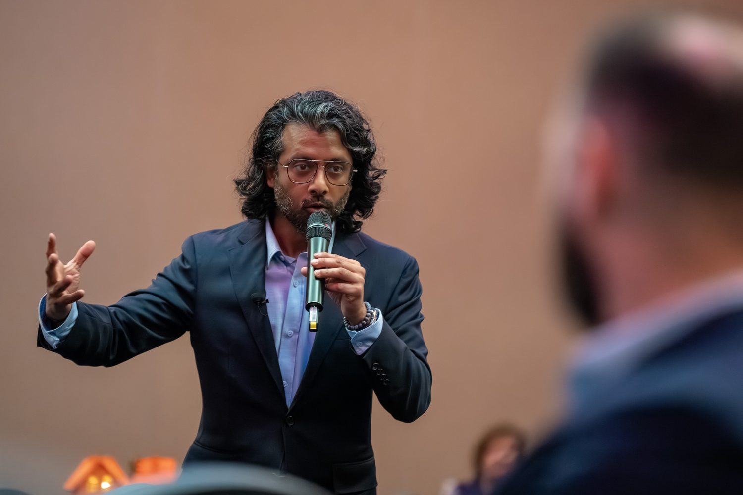 Speaker making a sweeping gesture while making a point