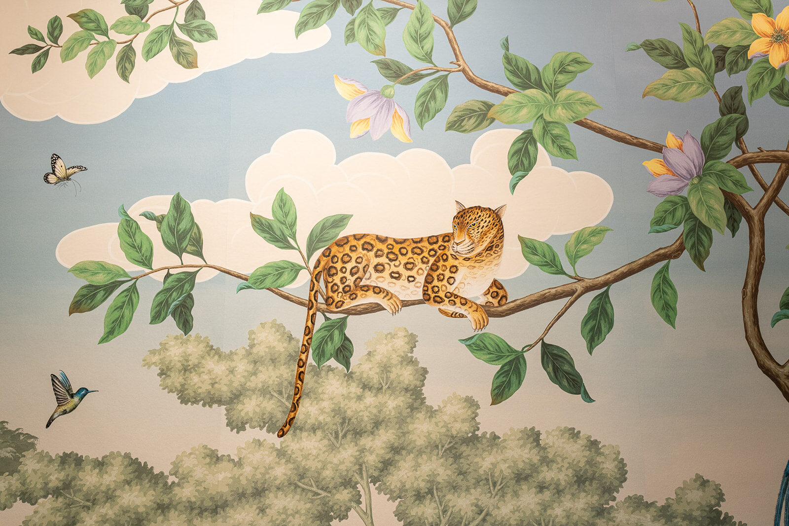 Close detail of a leopard resting on a painted branch