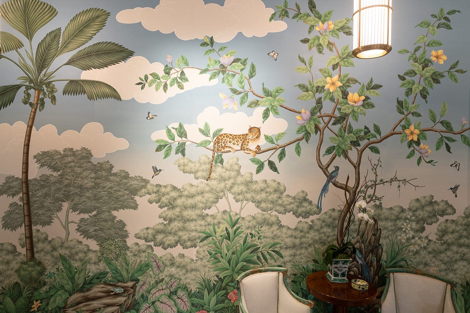 Mural detail of a leopard and clouded sky beside a lantern