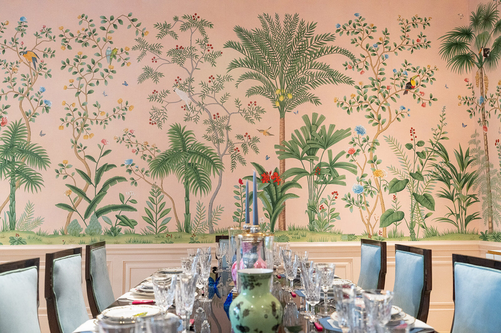 Dining table styled beneath a botanical chinoiserie mural
