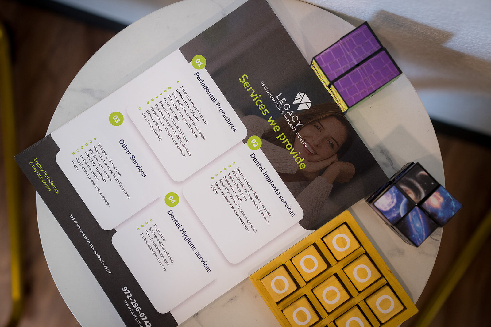 Legacy Periodontics services brochure on a table