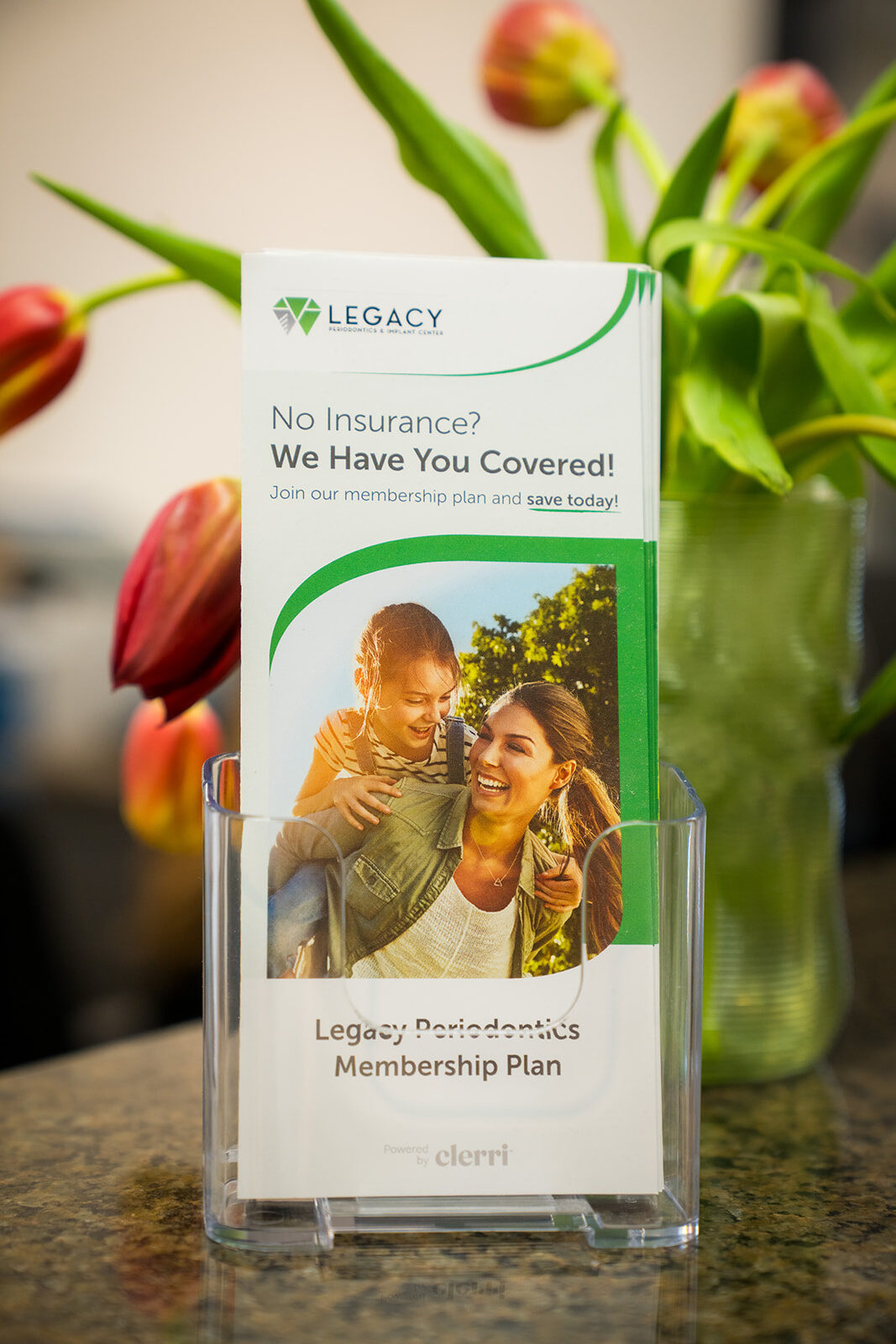 Legacy Periodontics membership plan brochure at the front desk