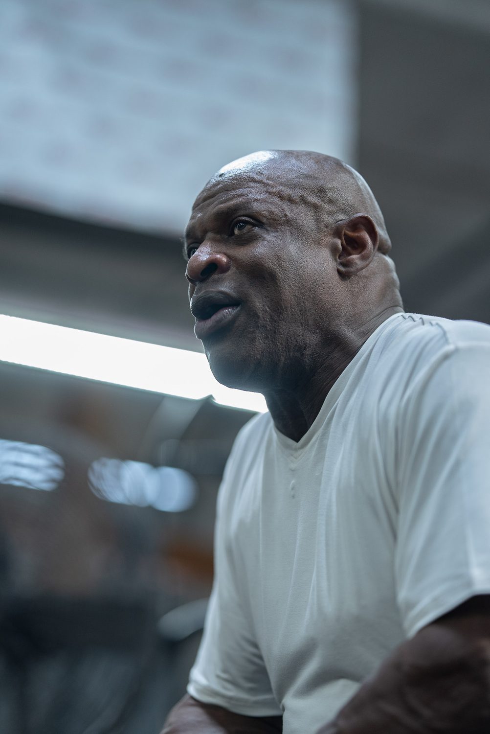 Profile portrait of Ronnie Coleman between sets in the gym