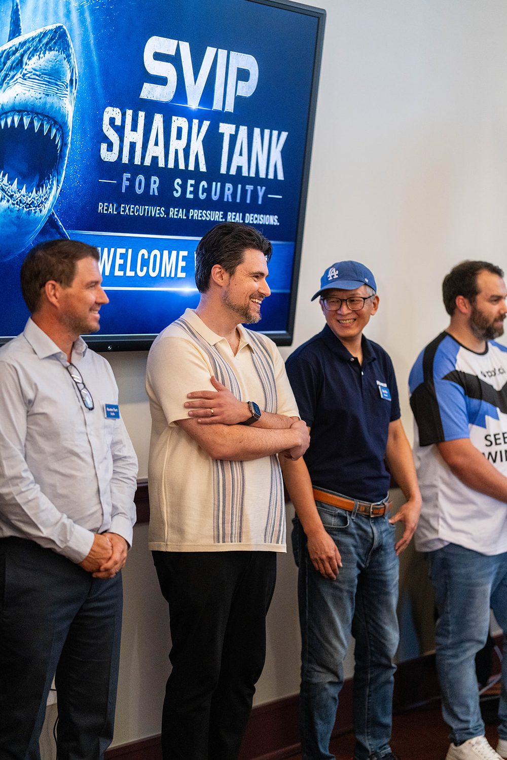 Presenters lined up beside the event welcome screen