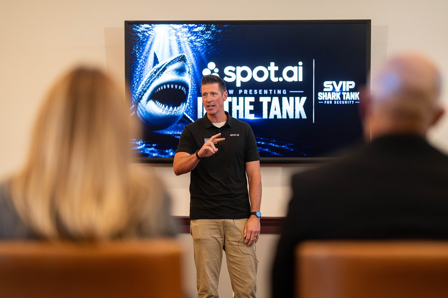Founder pitching in front of a branded Shark Tank presentation screen