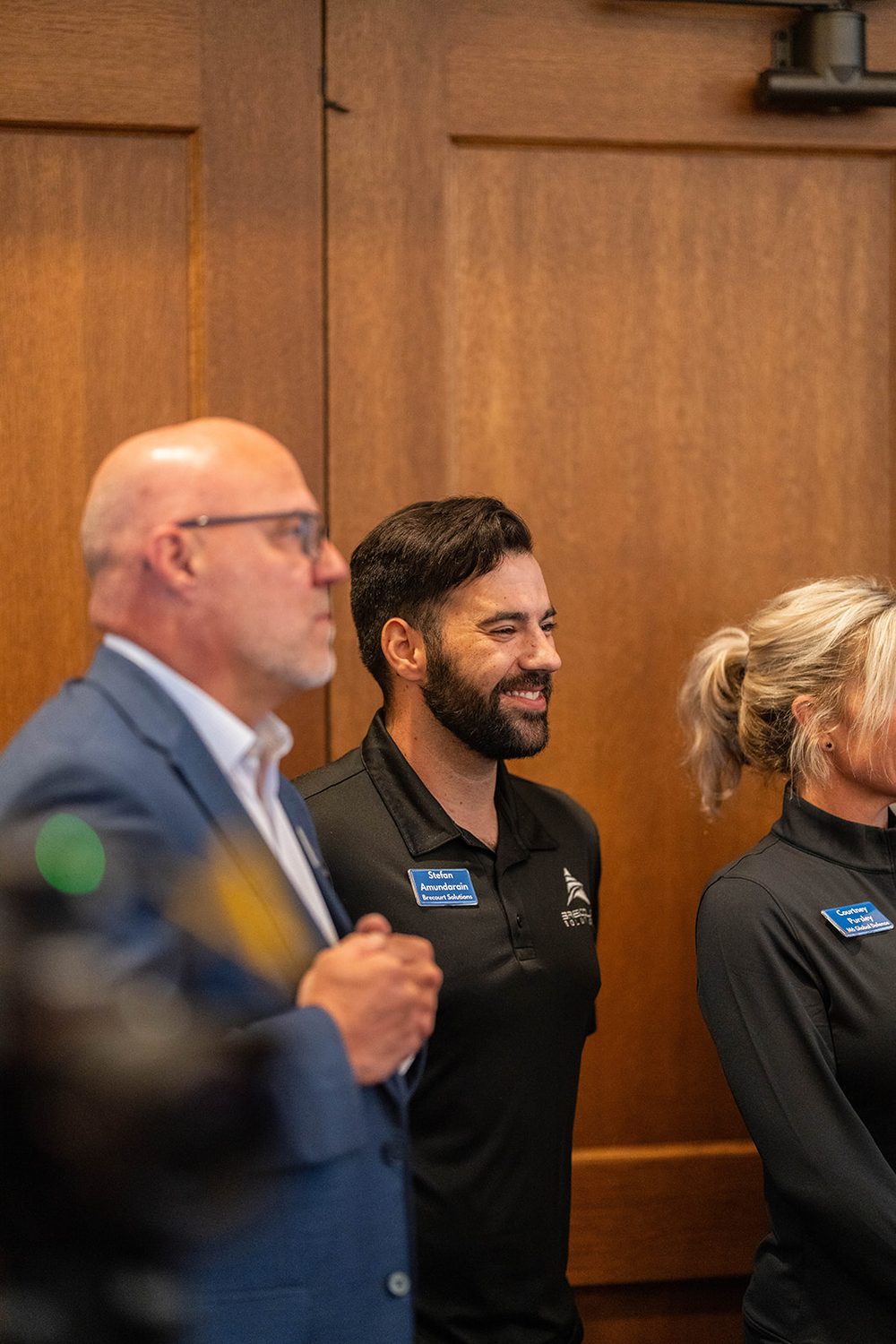 Attendees sharing a light moment between pitches