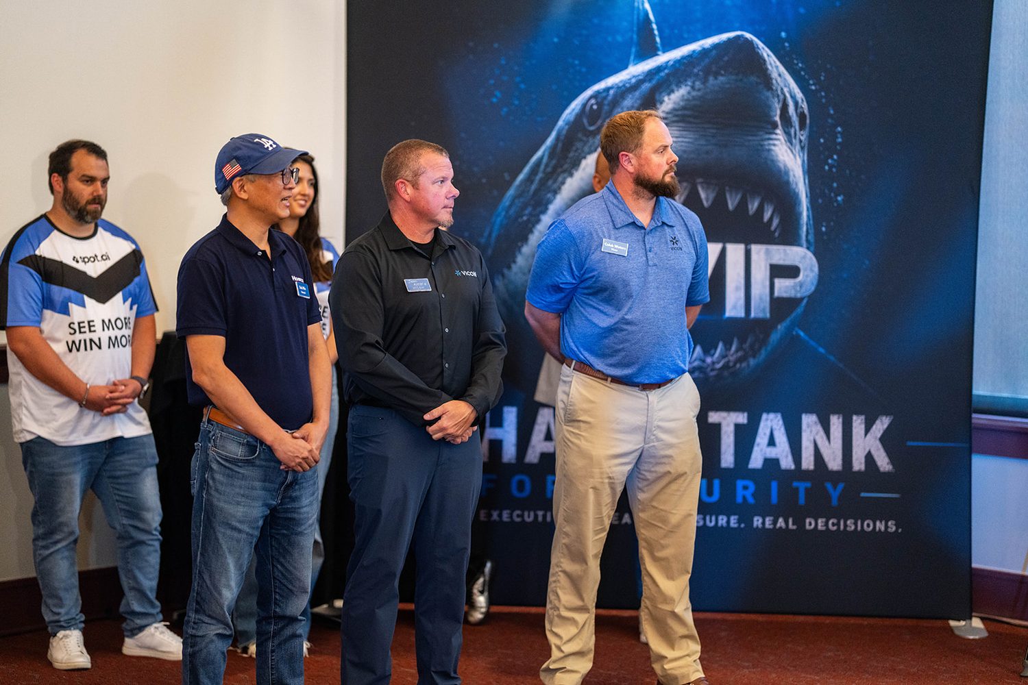 Finalists standing together in front of the Shark Tank backdrop
